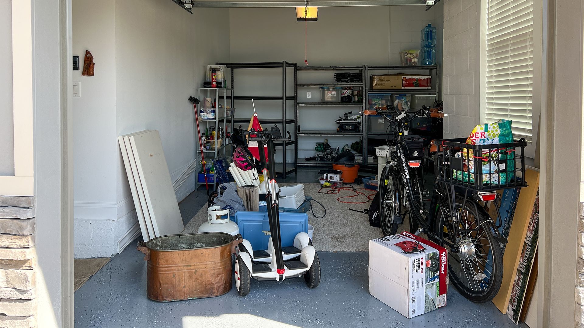 A garage filled with lots of toys and motorcycles.