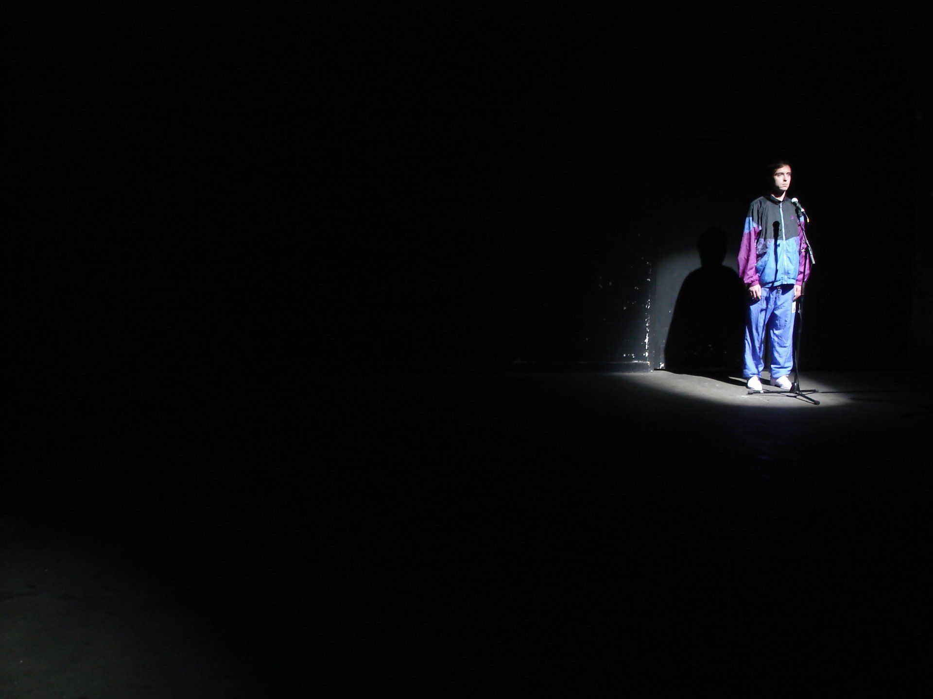 a man is standing in the dark with a flashlight .