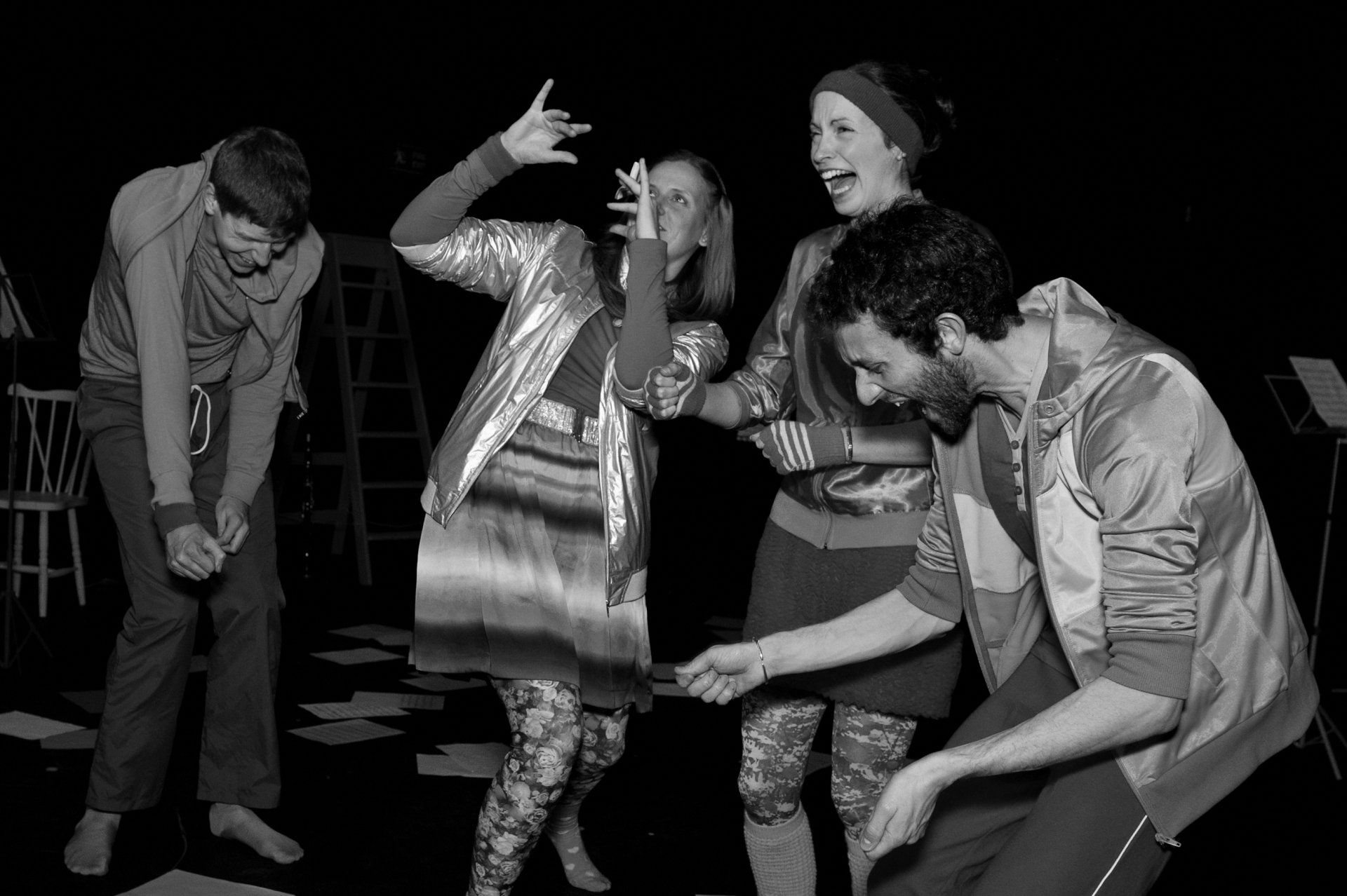 a group of people are dancing together in a black and white photo .