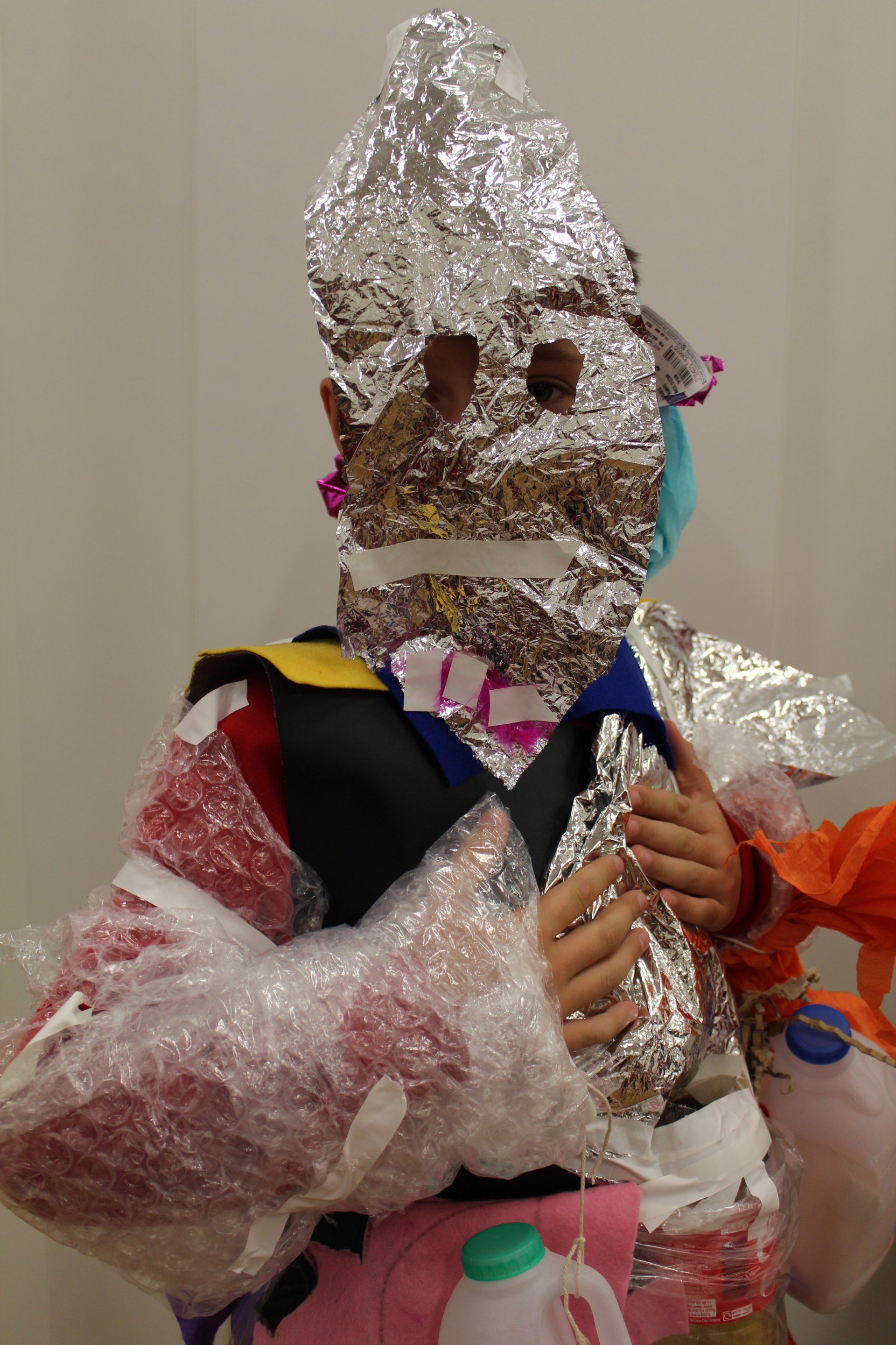 a person is wrapped in aluminum foil and plastic wrap