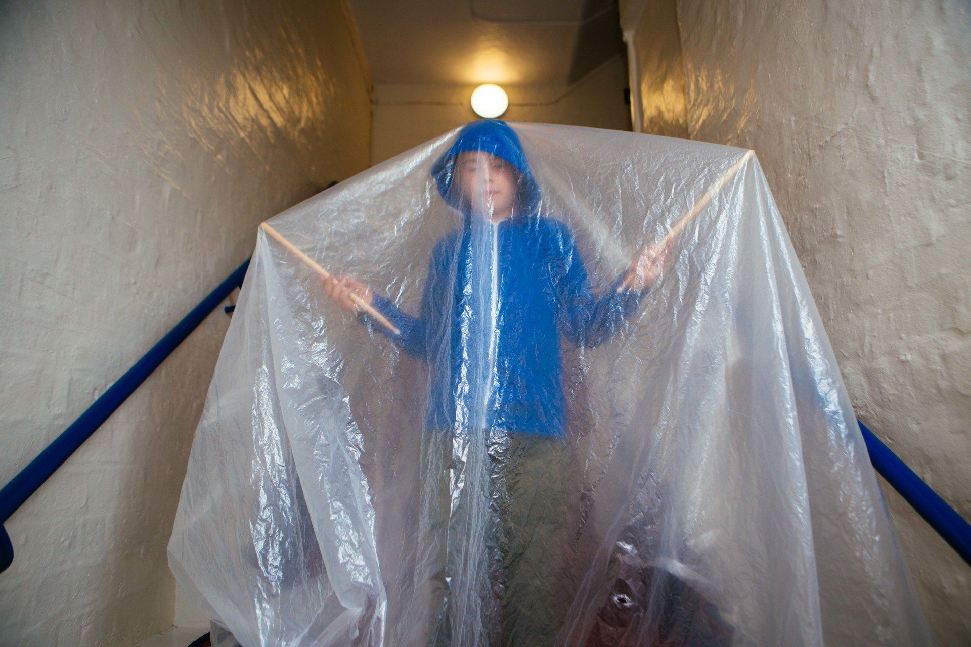 a person is standing on a set of stairs covered in plastic .