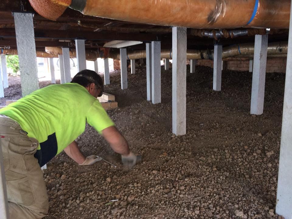Man Under the House Removing Dirt — Melbourne, VIC — Special Reblocking Services