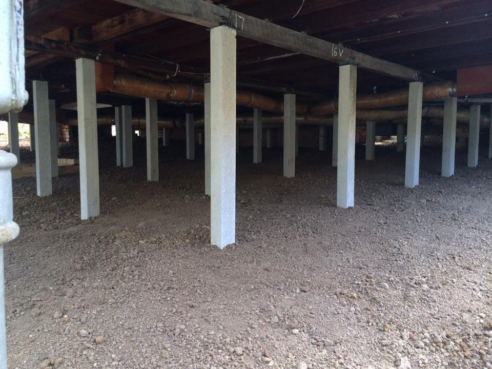 The Foundation of a House With Concrete Pillars and Gravel — Melbourne, VIC — Special Reblocking Services