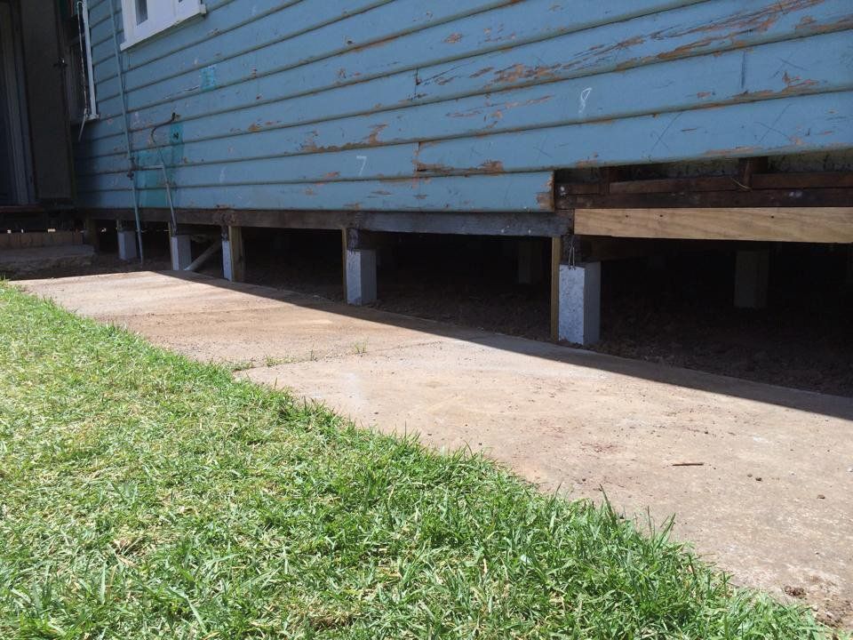 A Blue House With a Sidewalk and Grass in Front of It — Melbourne, VIC — Special Reblocking Services