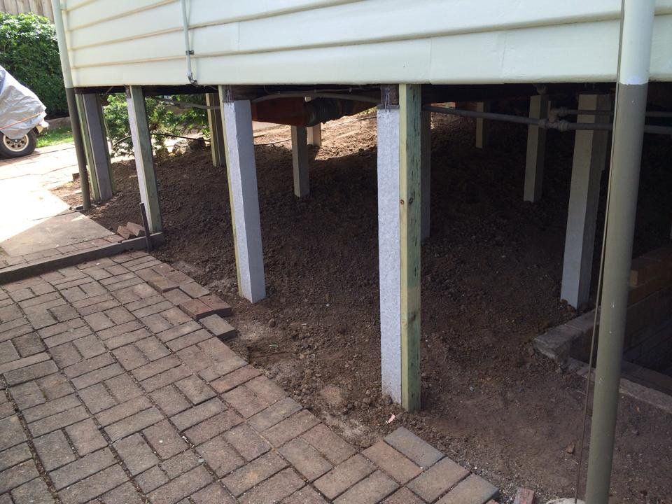 A Brick Walkway With a White House in the Background — Melbourne, VIC — Special Reblocking Services