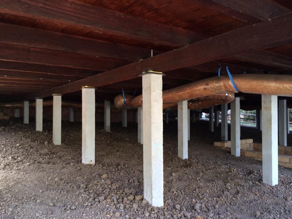 The Underside of a House With Concrete Pillars and Wooden Beams — Melbourne, VIC — Special Reblocking Services