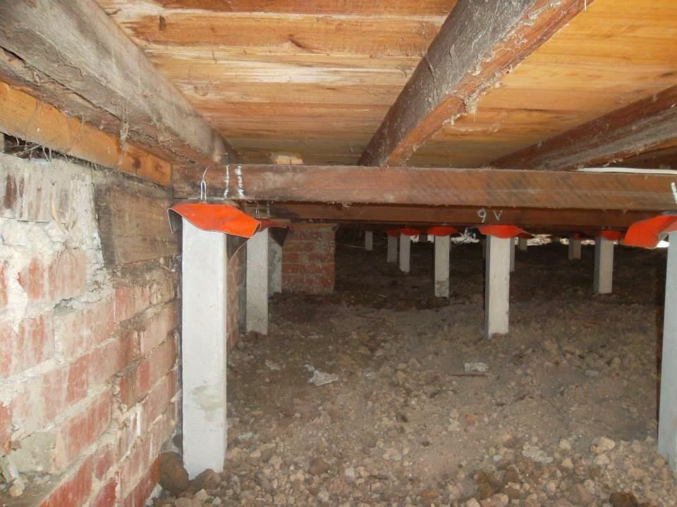 A Crawl Space With a Wooden Floor and Brick Walls — Melbourne, VIC — Special Reblocking Services