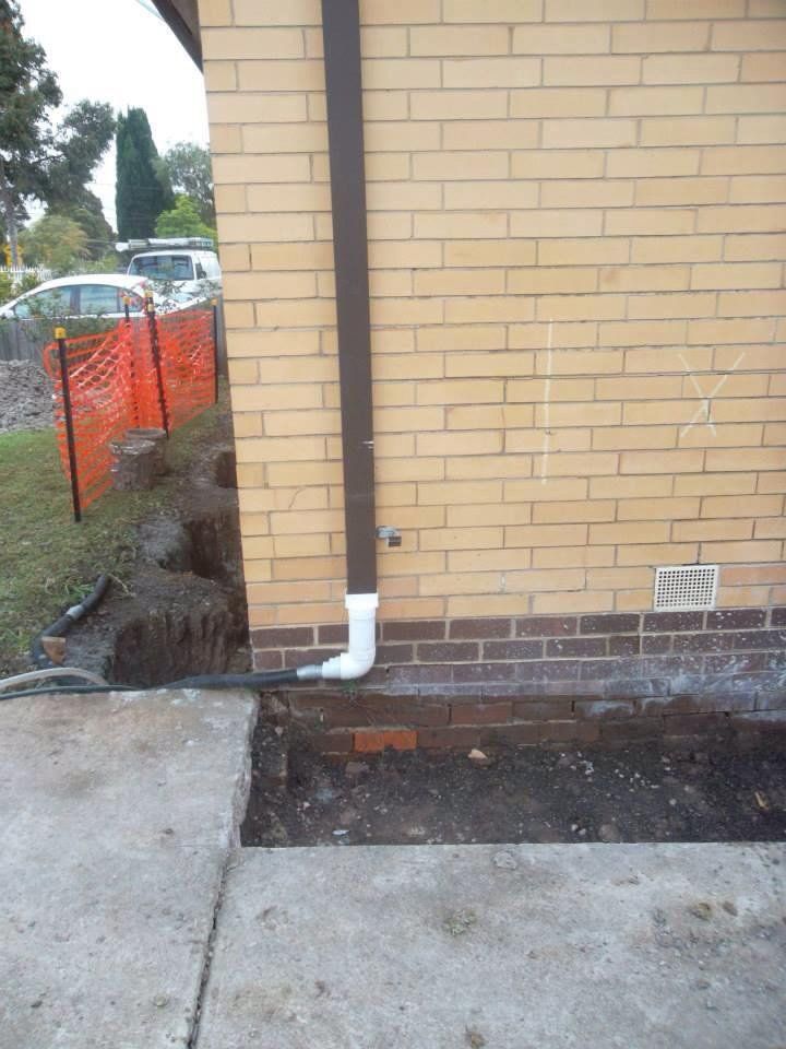 A Brick Wall With a Drain Pipe Attached to It — Melbourne, VIC — Special Reblocking Services