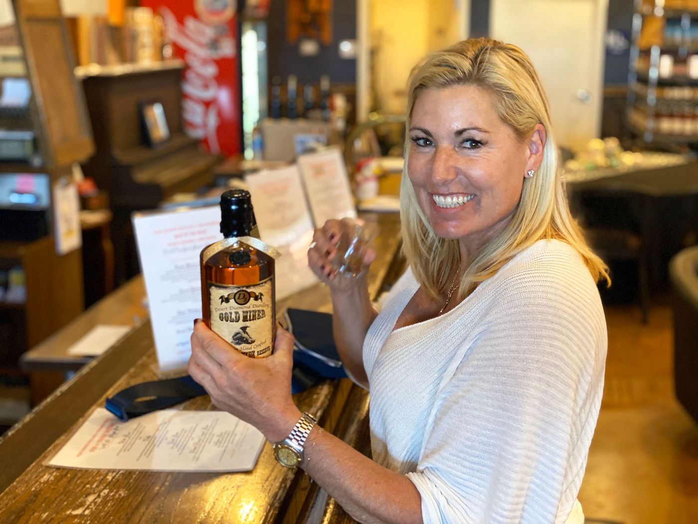 Woman holding bottle.