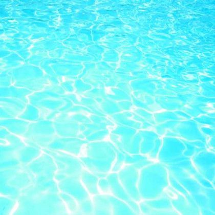 A close up of the water in a swimming pool.