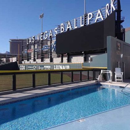 A swimming pool in front of a large sign that says las vegas ballpark