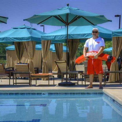 A man holding a life preserver with the word guard on it