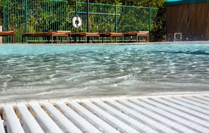 A swimming pool with a life preserver on the side of it.