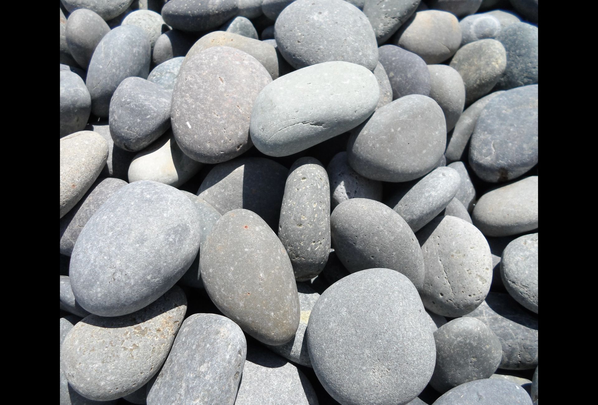 A pile of gray beach rocks sitting on top of each other