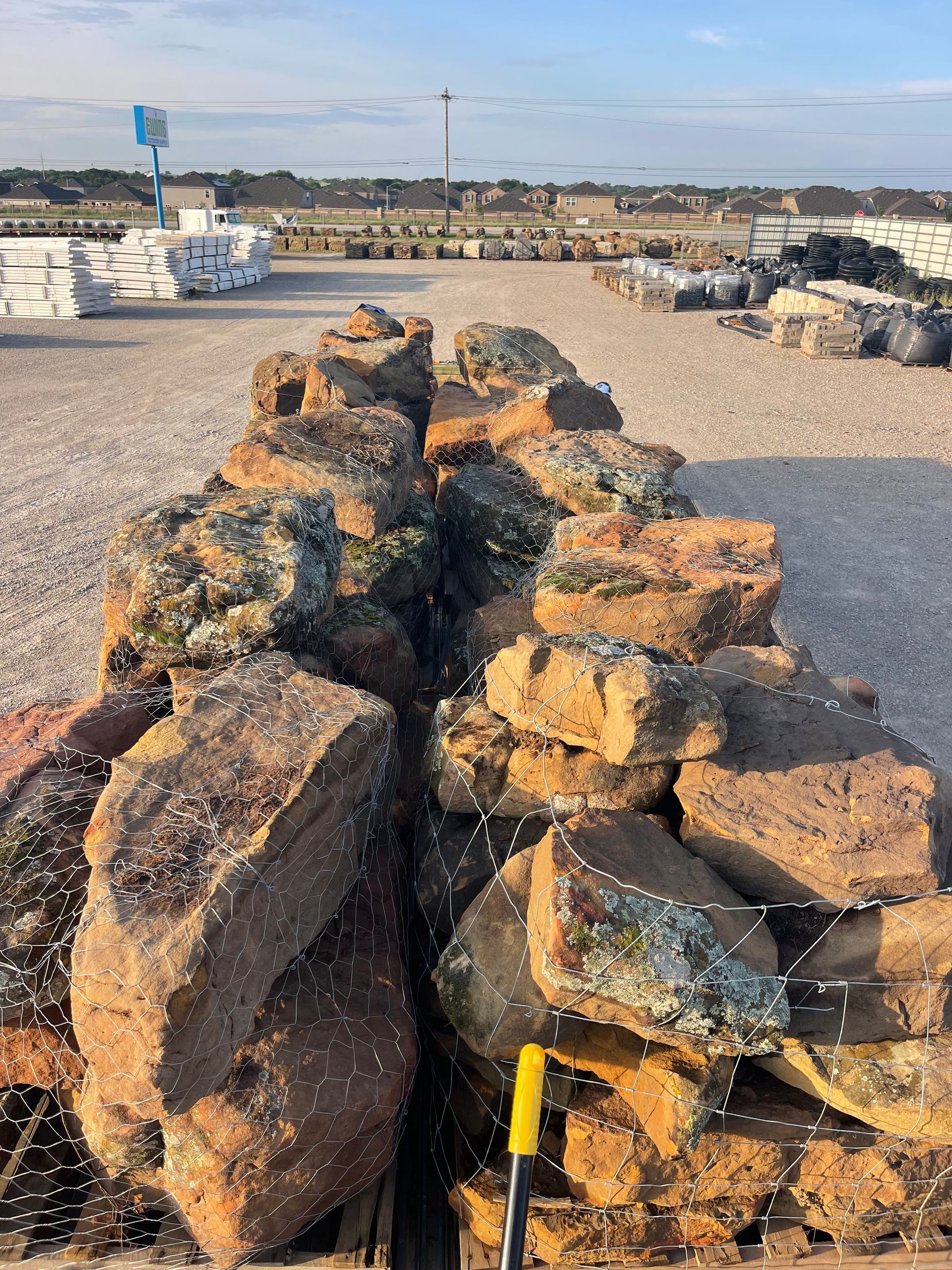 A pile of rocks with a yellow shovel next to them.