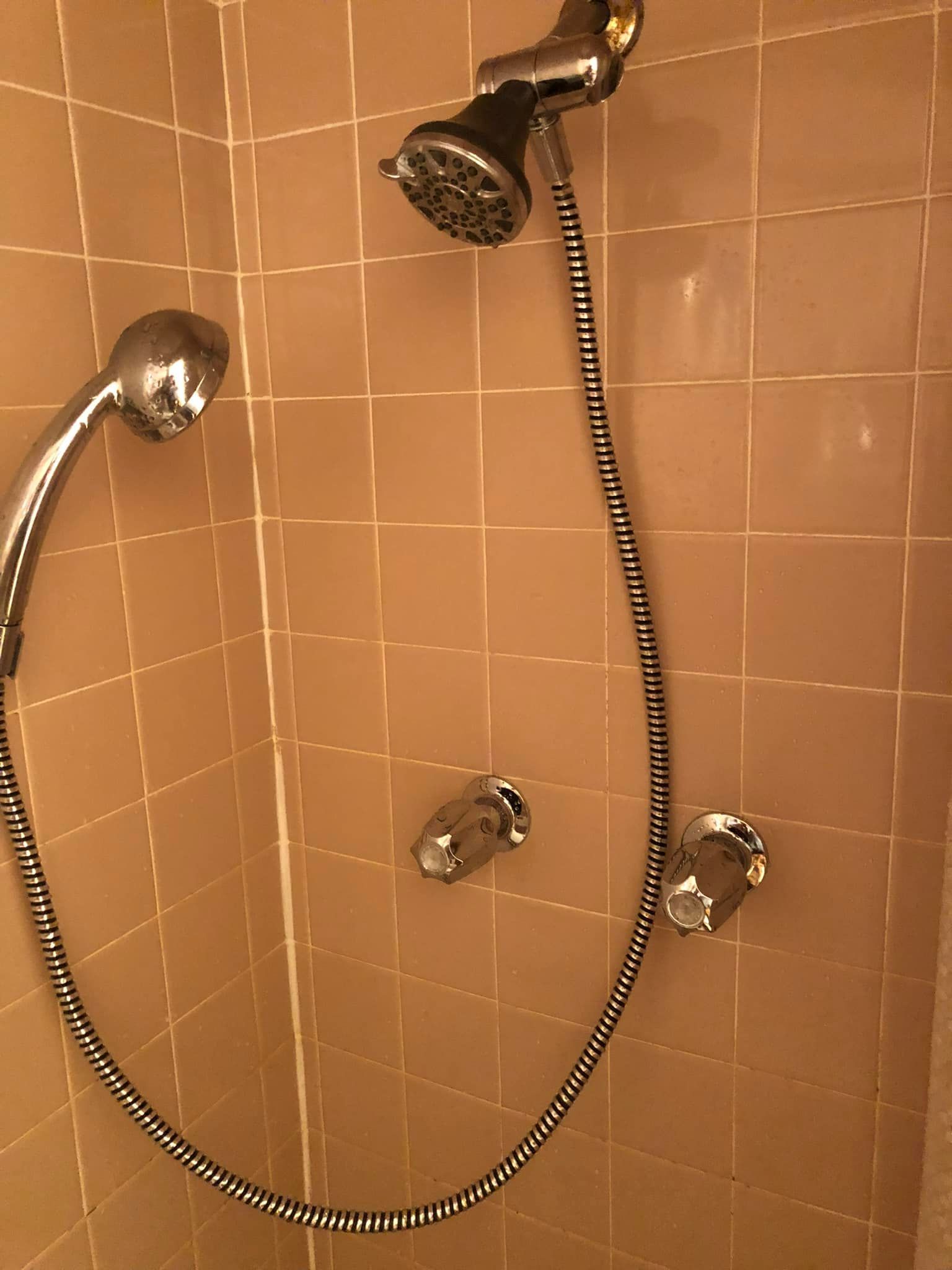 A shower head with a hose attached to it