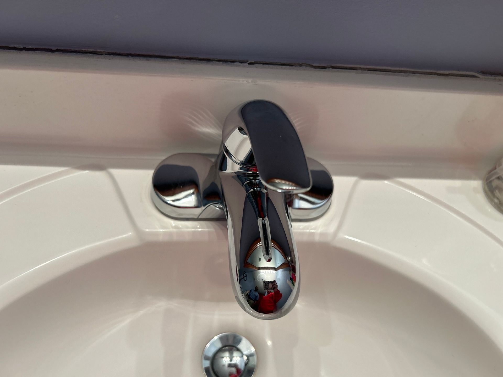 A bathroom sink with a chrome faucet on it