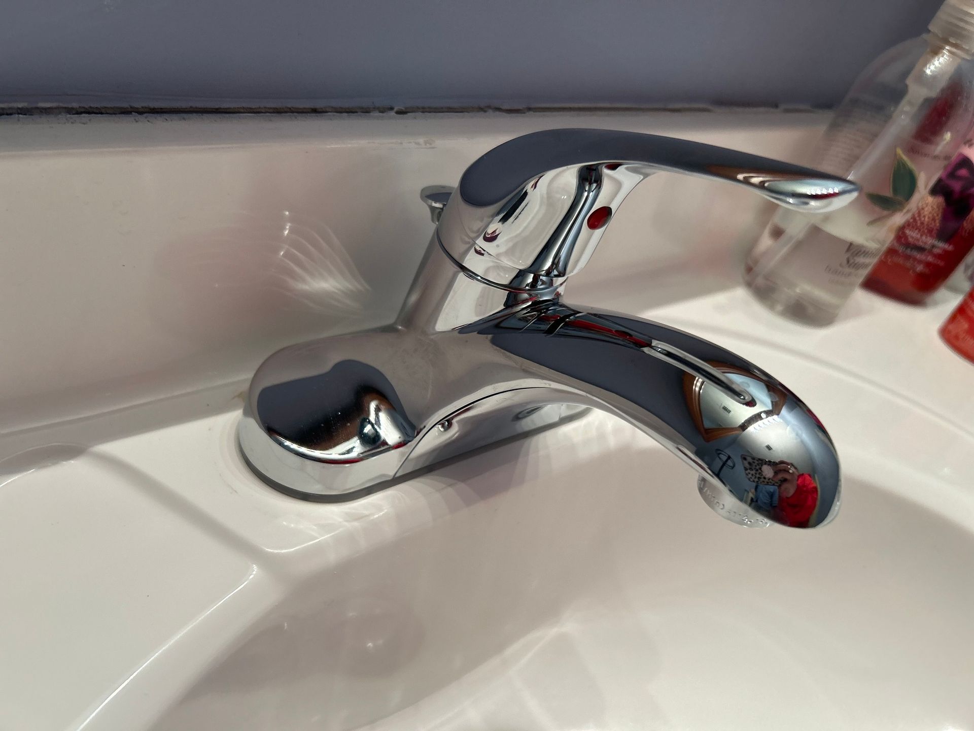 A bathroom sink with a chrome faucet on it