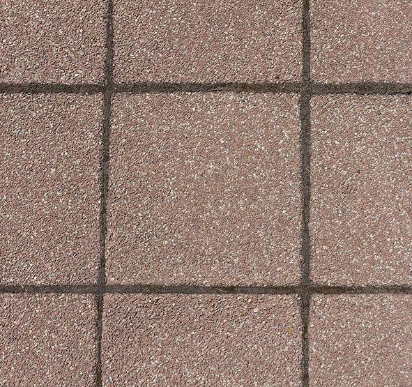 a close up of a brown tile floor with a black border .