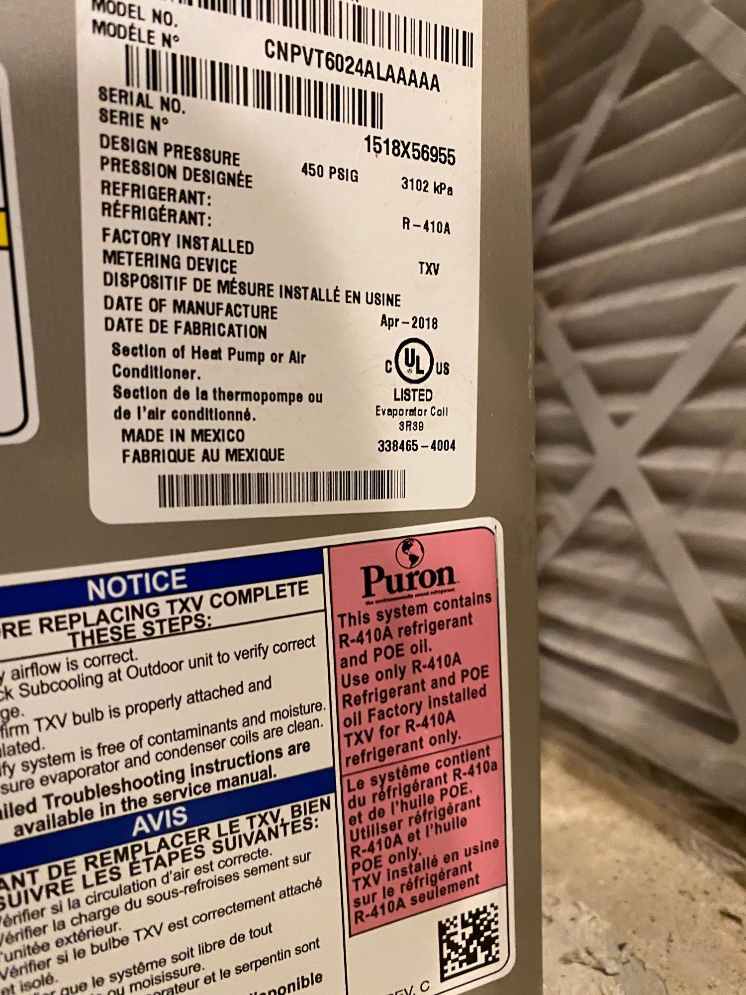 a notice sticker on the side of a puron air conditioner