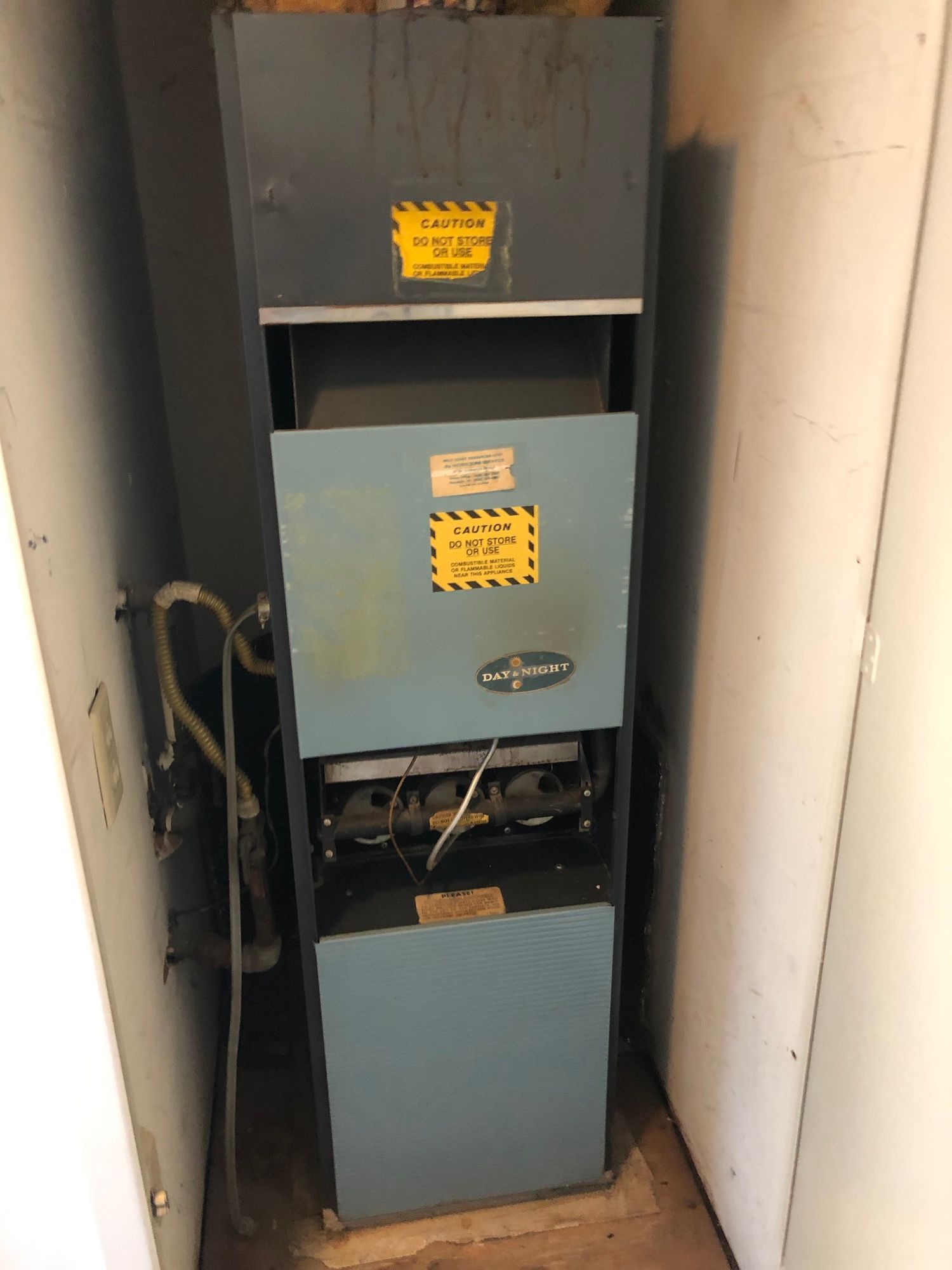 a blue heater is sitting in a corner of a room .