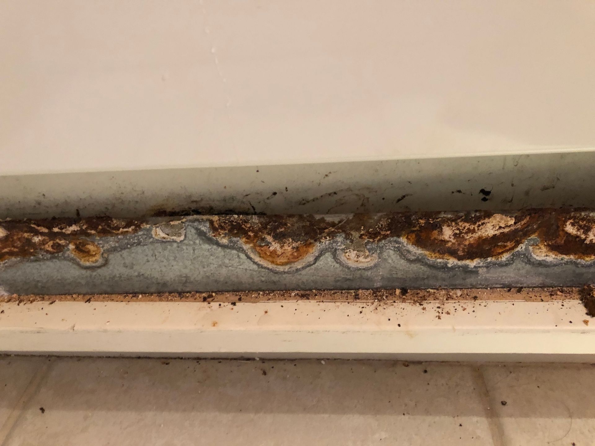 a close up of a rusty piece of metal on a wall .