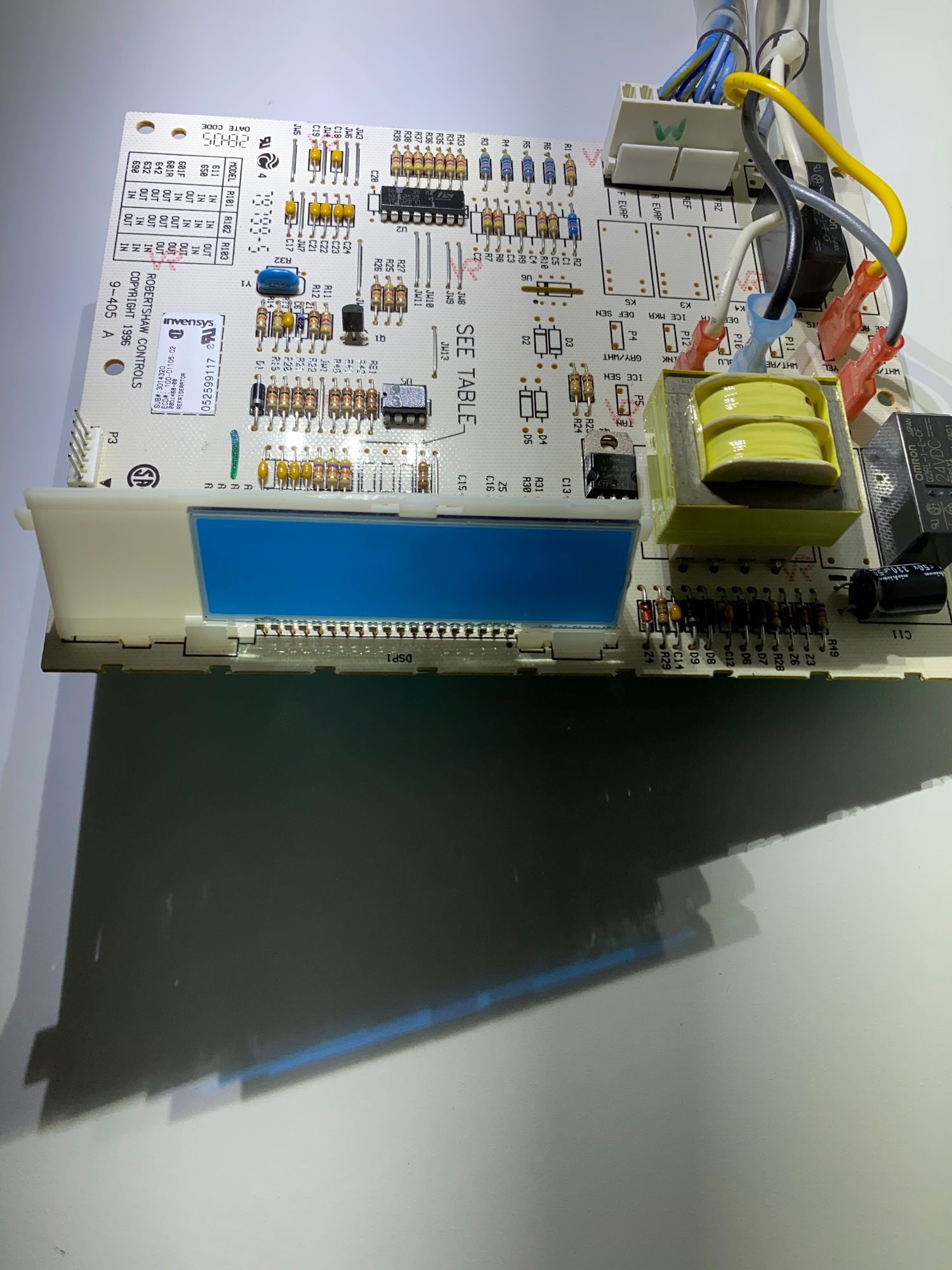 a motherboard with a blue screen is sitting on a table .