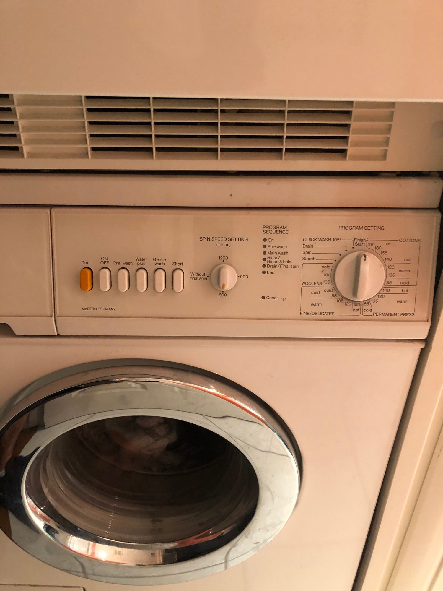 a white washer and dryer are stacked on top of each other .