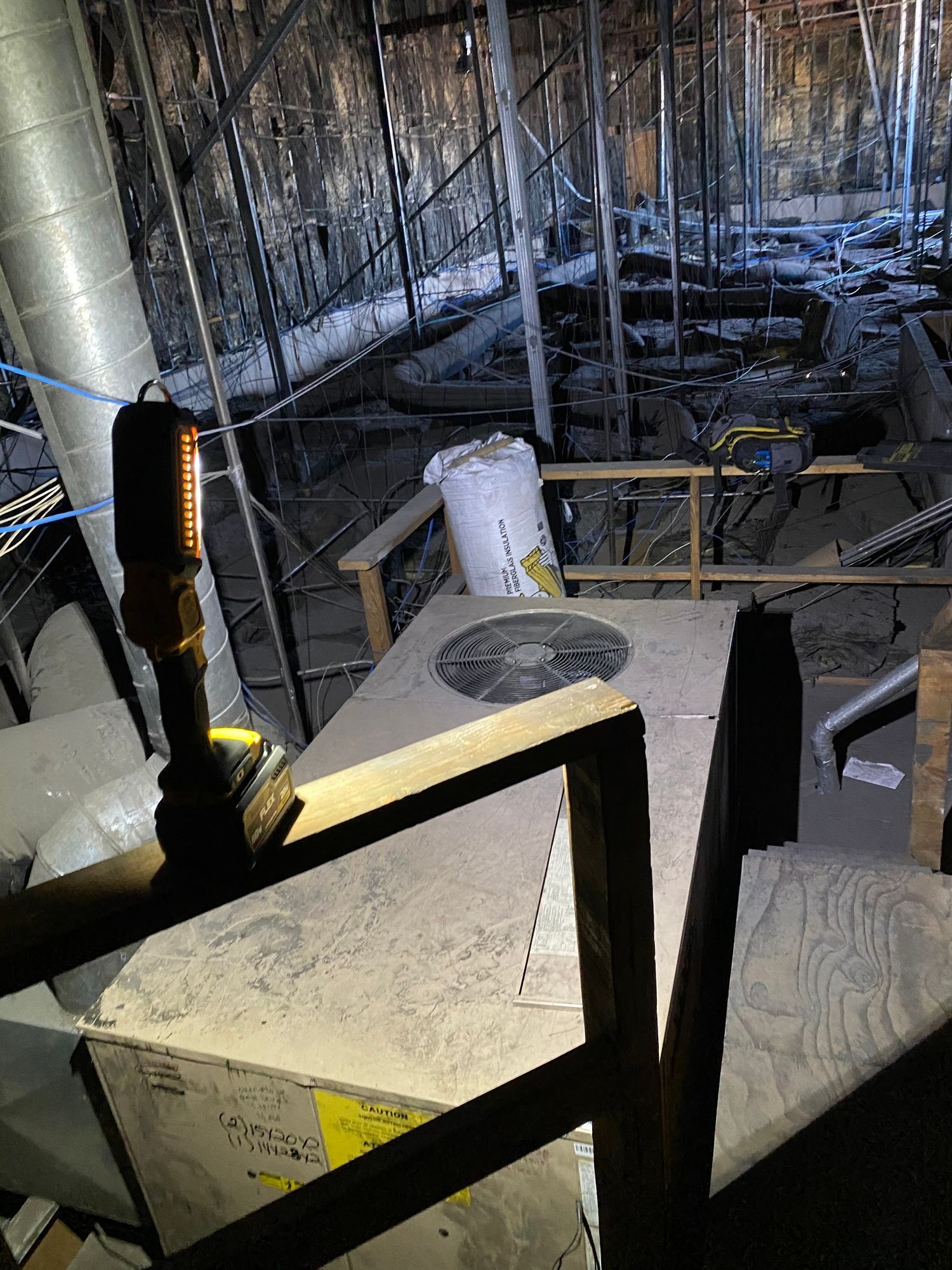 a room with a lot of scaffolding and a fan on the floor .