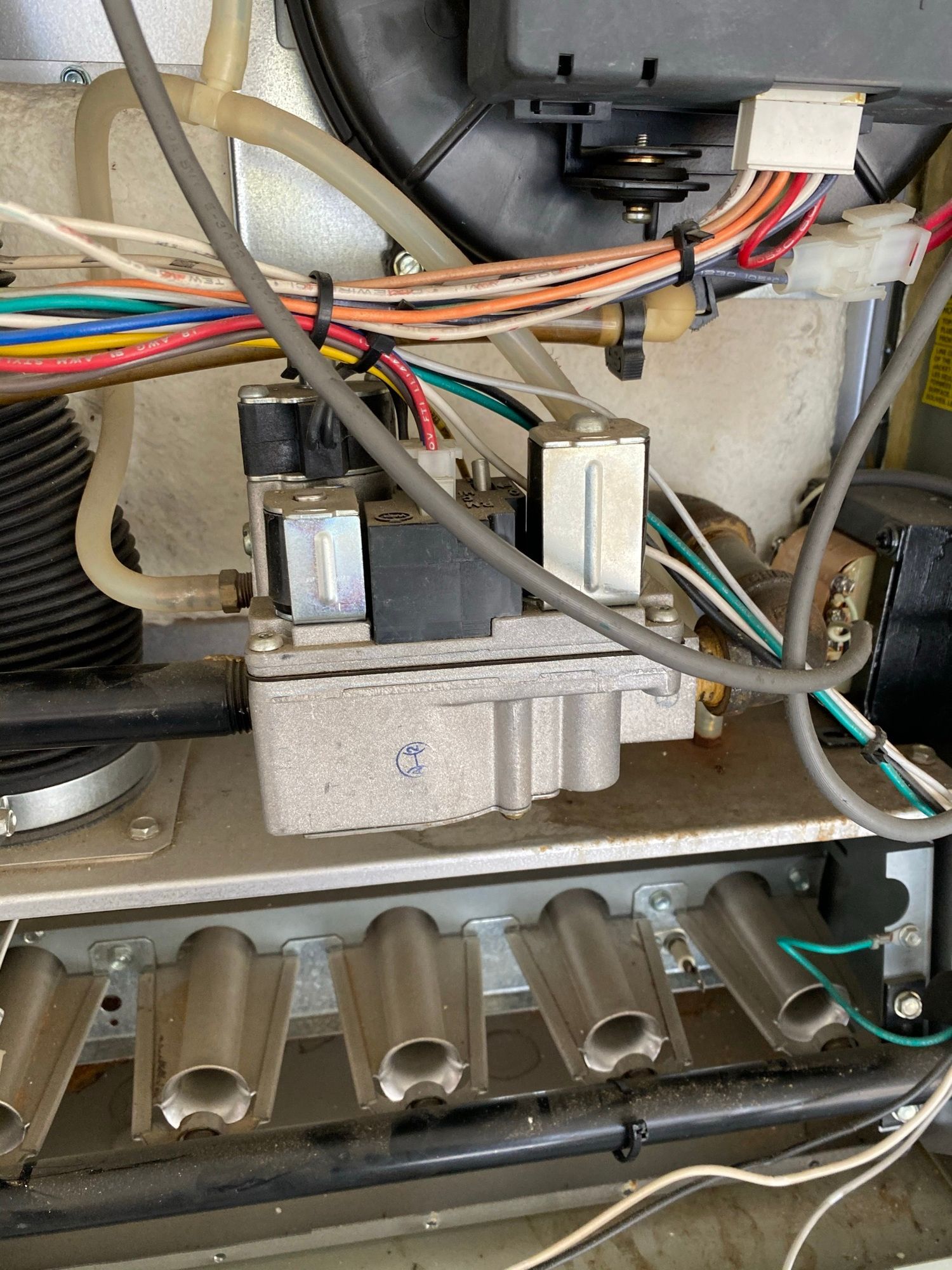 a close up of a stove with a bunch of wires coming out of it .