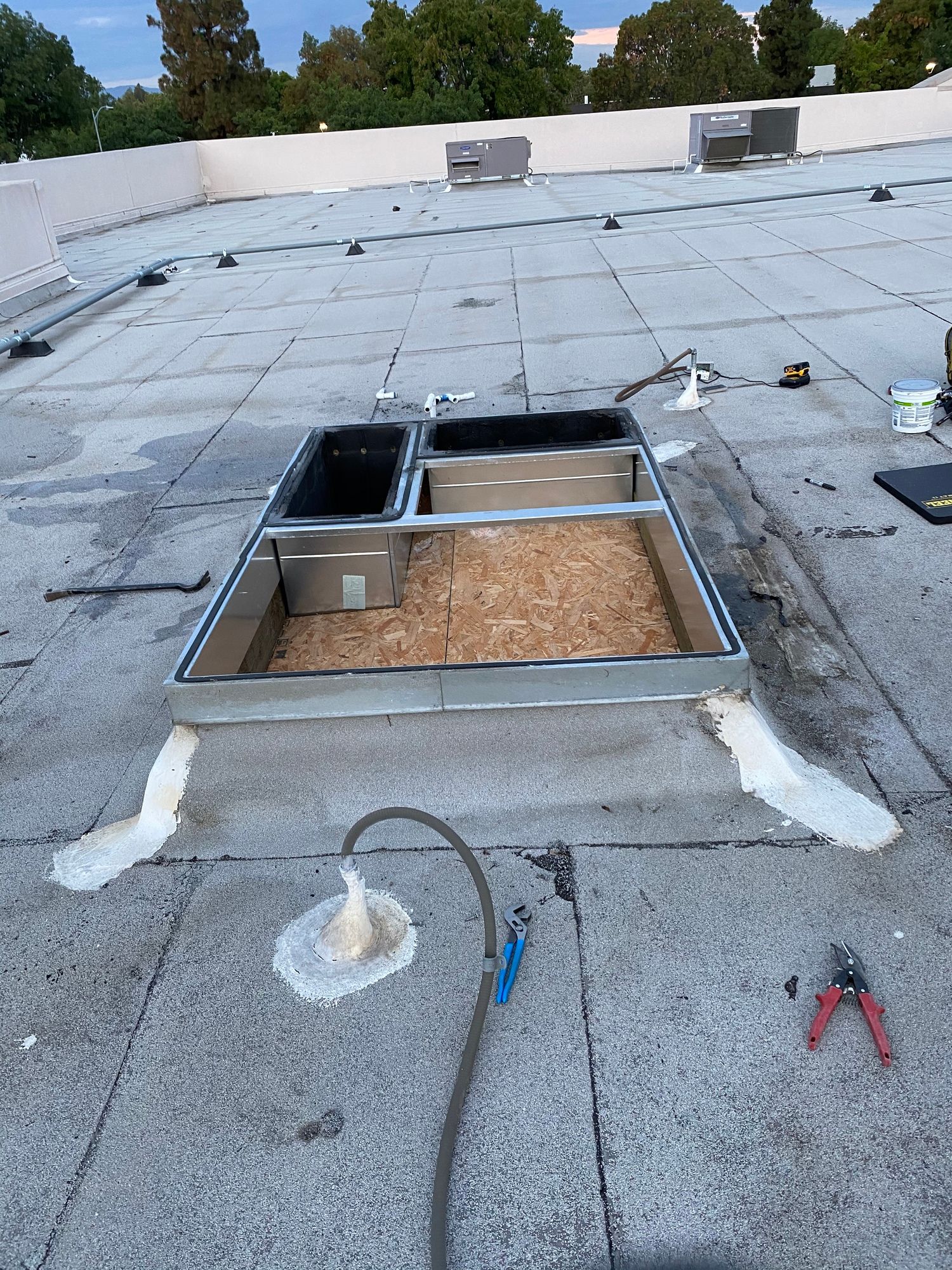 a roof with a skylight being installed on it .