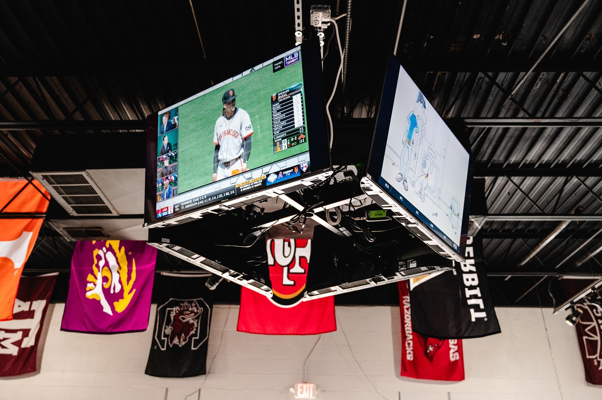 A group of people are watching a soccer game in a bar.