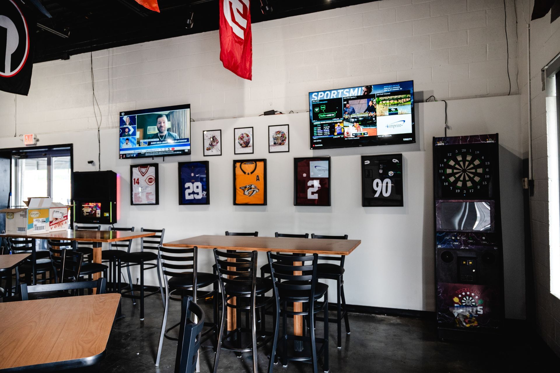 A group of people are watching a soccer game in a bar.