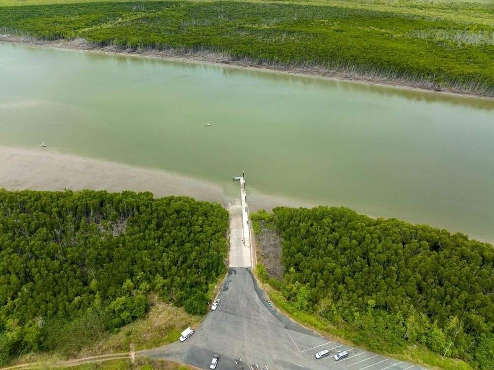 An Aerial View of A Road Leading to A Body of Water Surrounded by Trees — McGuire Air & Refrigeration in Proserpine, QLD