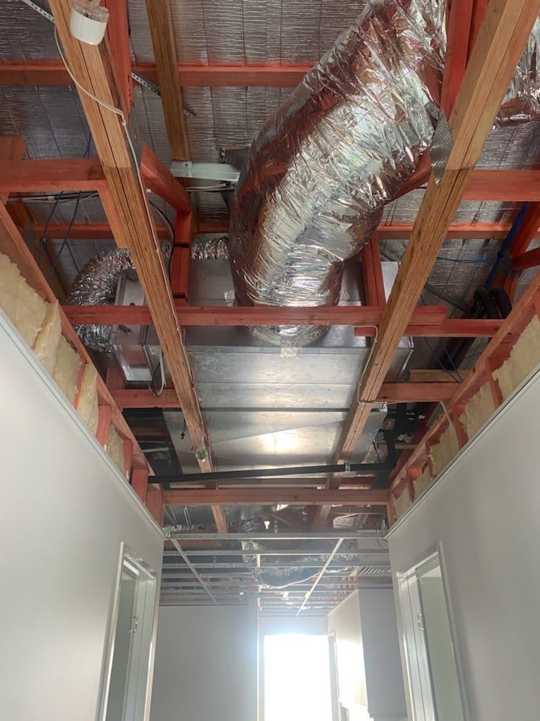 A Hallway with A Ceiling that Has a Lot of Pipes Coming out Of It — McGuire Air & Refrigeration In Paget, QLD