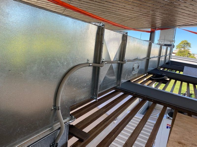 A Balcony with A Metal Wall and A Wooden Floor — McGuire Air & Refrigeration In Paget, QLD