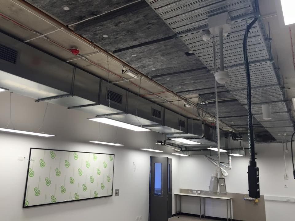 A Room with A Ceiling that Has a Lot of Wires Hanging from It — McGuire Air & Refrigeration In Paget, QLD