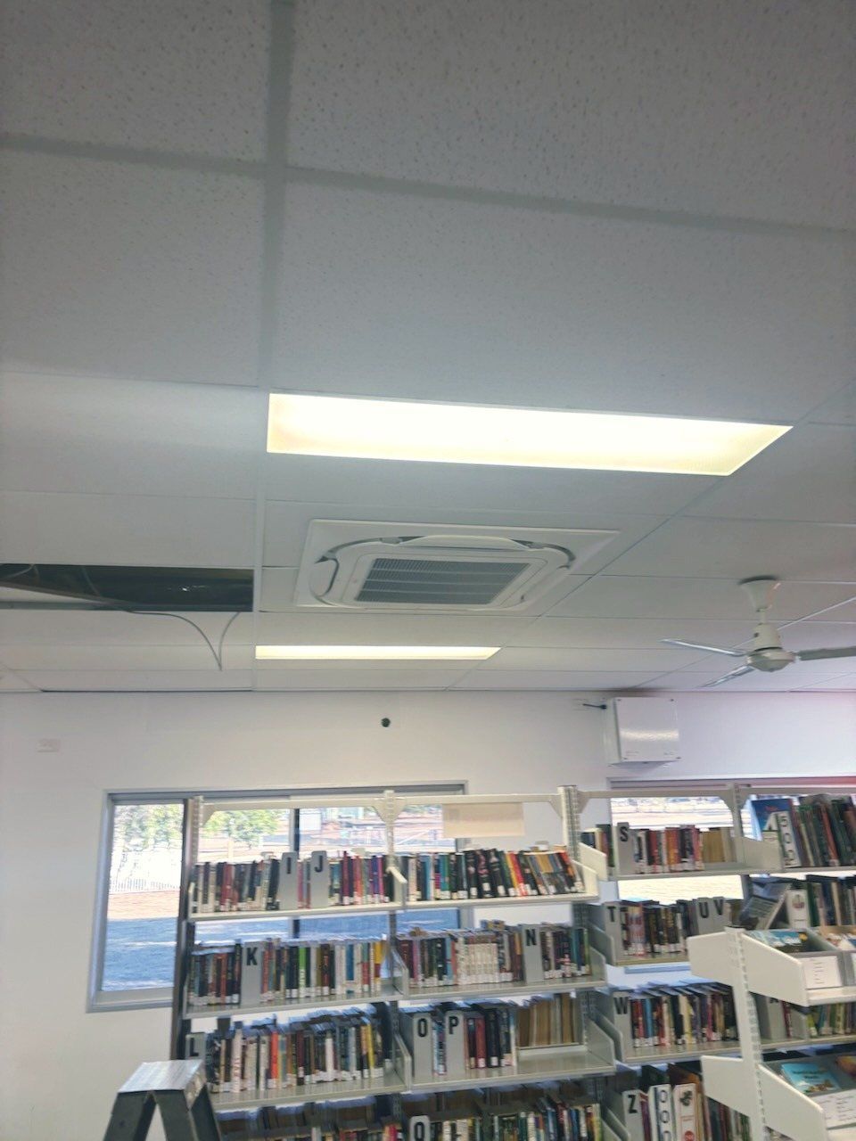 A Library with A Lot of Books on The Shelves — McGuire Air & Refrigeration In Paget, QLD