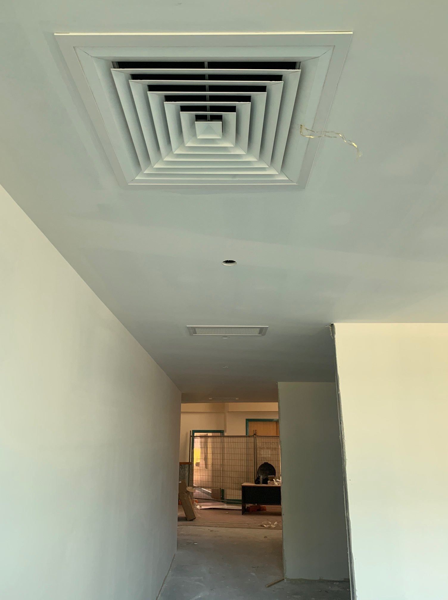A Hallway with A Square Air Vent on The Ceiling — McGuire Air & Refrigeration In Paget, QLD