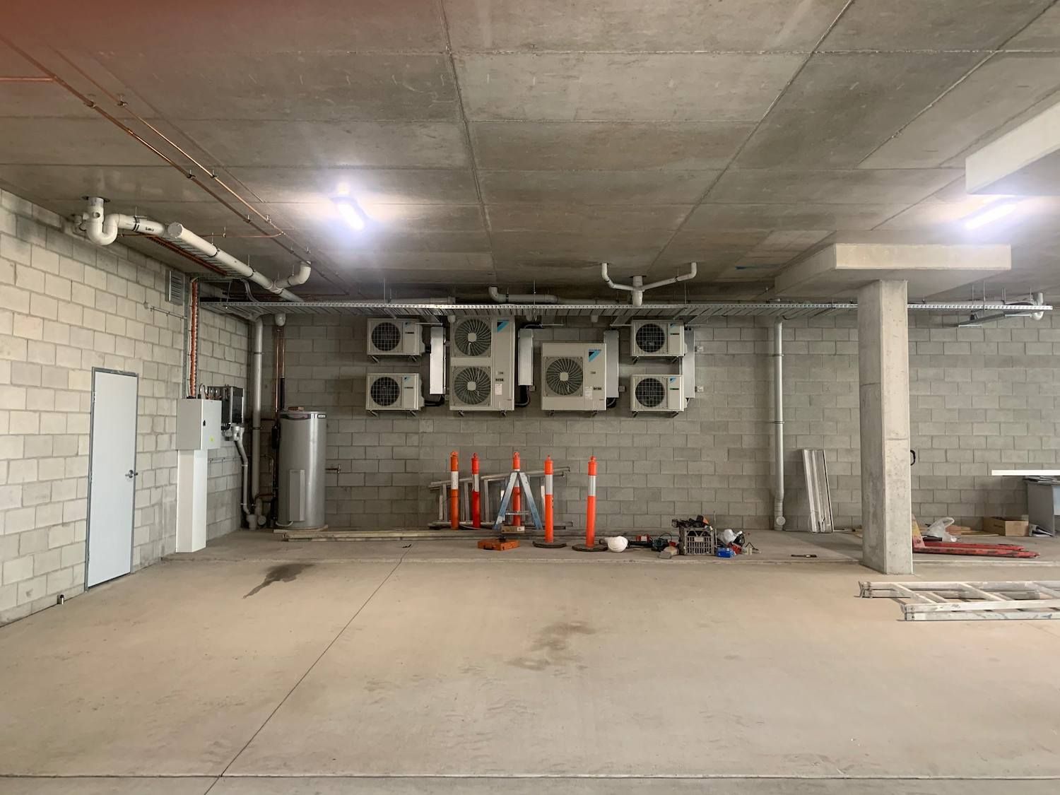 There Are a Lot of Air Conditioners Hanging from The Ceiling of A Building — McGuire Air & Refrigeration In Paget, QLD