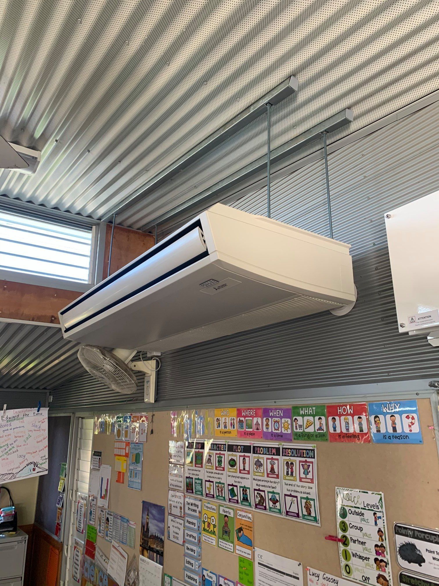 A Classroom with A Lot of Drawings on The Wall and A Ceiling Fan — McGuire Air & Refrigeration In Paget, QLD