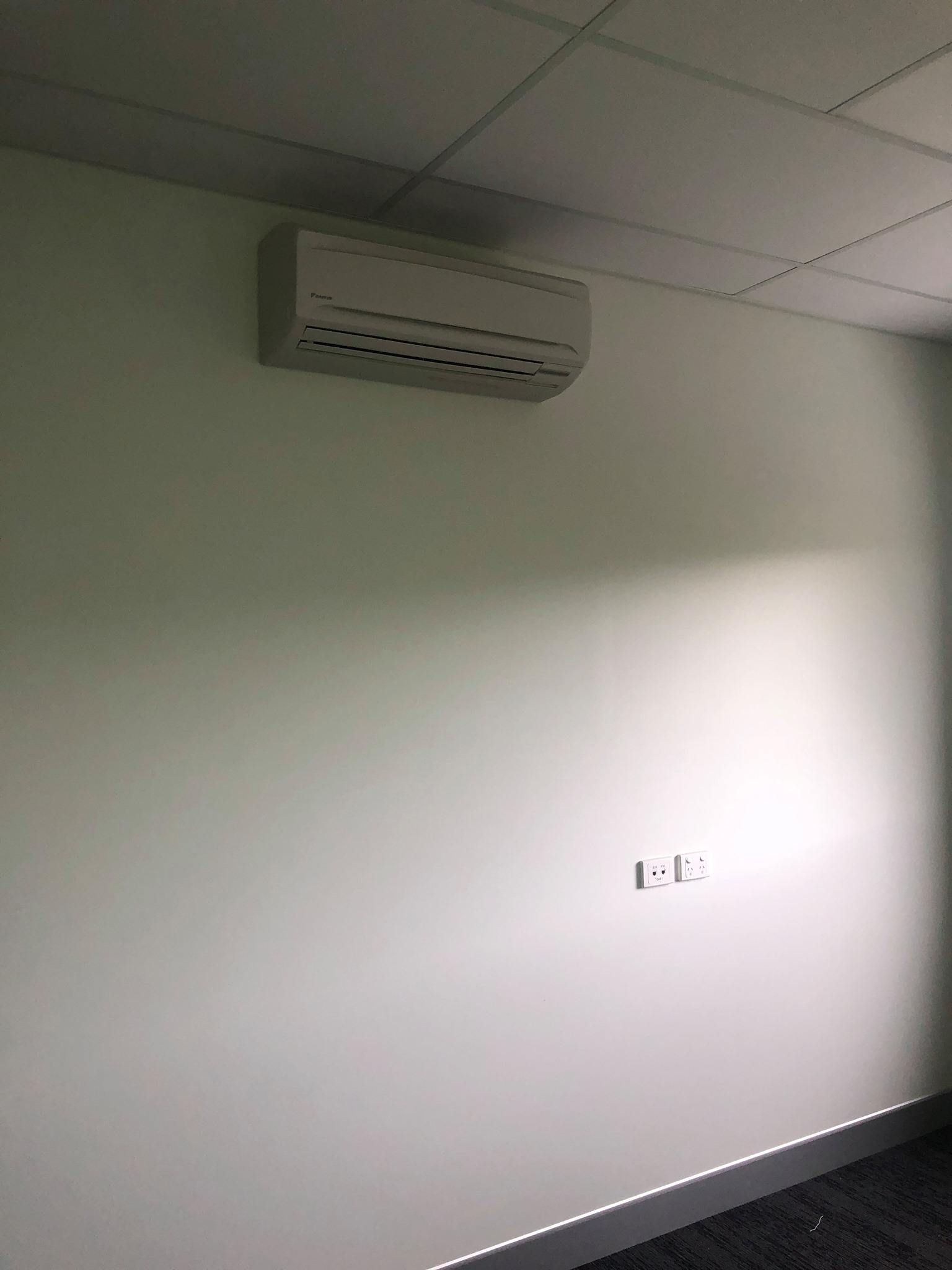 A Room with A White Wall and A White Air Conditioner on The Wall — McGuire Air & Refrigeration In Paget, QLD