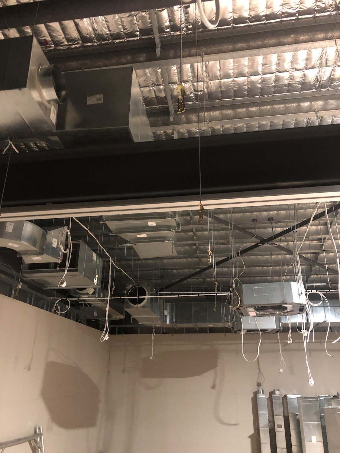 A Room with A Lot of Pipes Hanging from The Ceiling — McGuire Air & Refrigeration In Paget, QLD