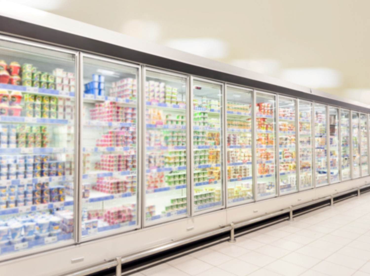A Row of Refrigerators in A Supermarket Filled with Lots of Food — McGuire Air & Refrigeration In Paget, QLD
