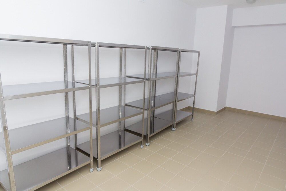 A Row of Stainless Steel Shelves in An Empty Room — McGuire Air & Refrigeration In Paget, QLD