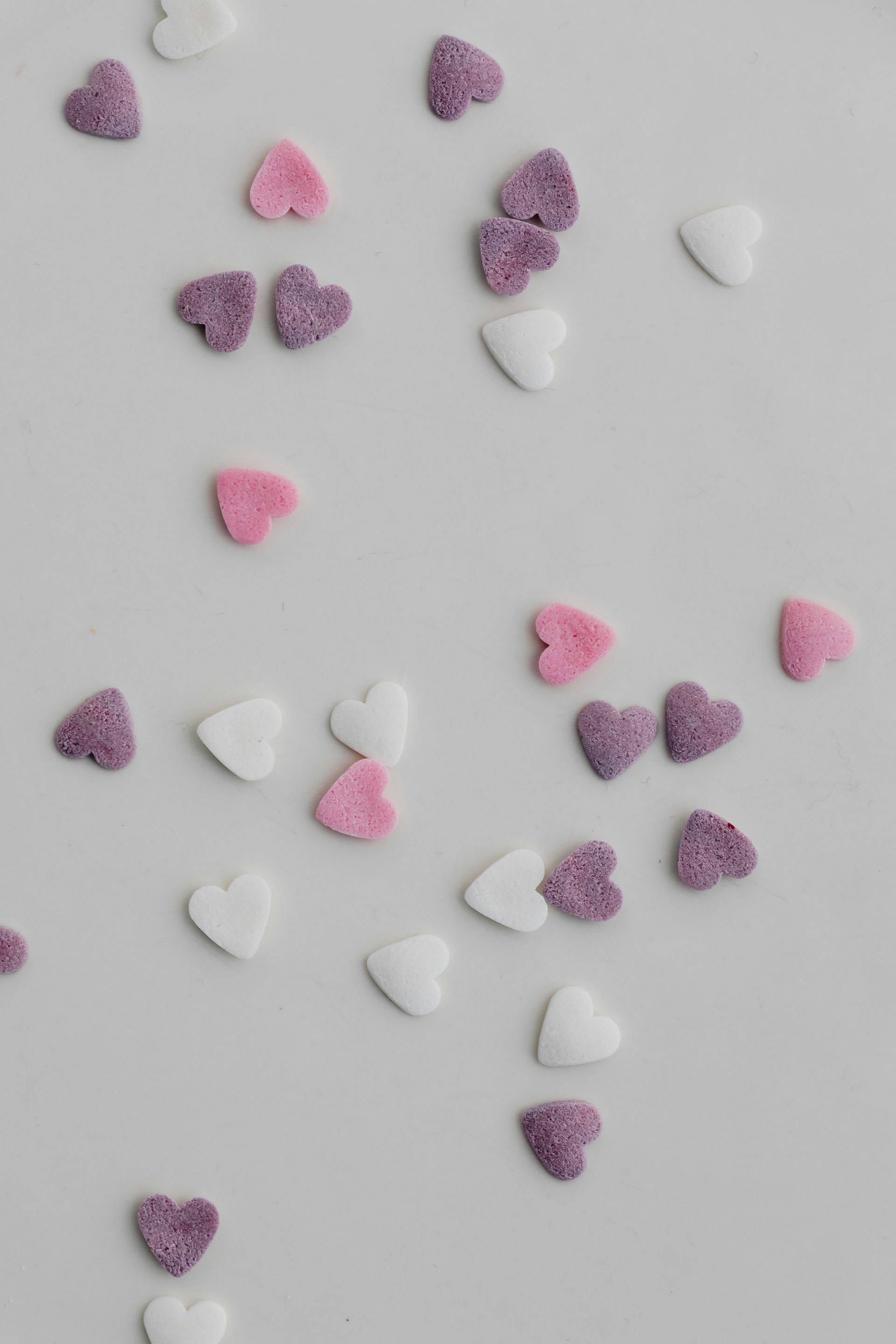 Candy sprinkle hearts in three colors represent open relationship. 