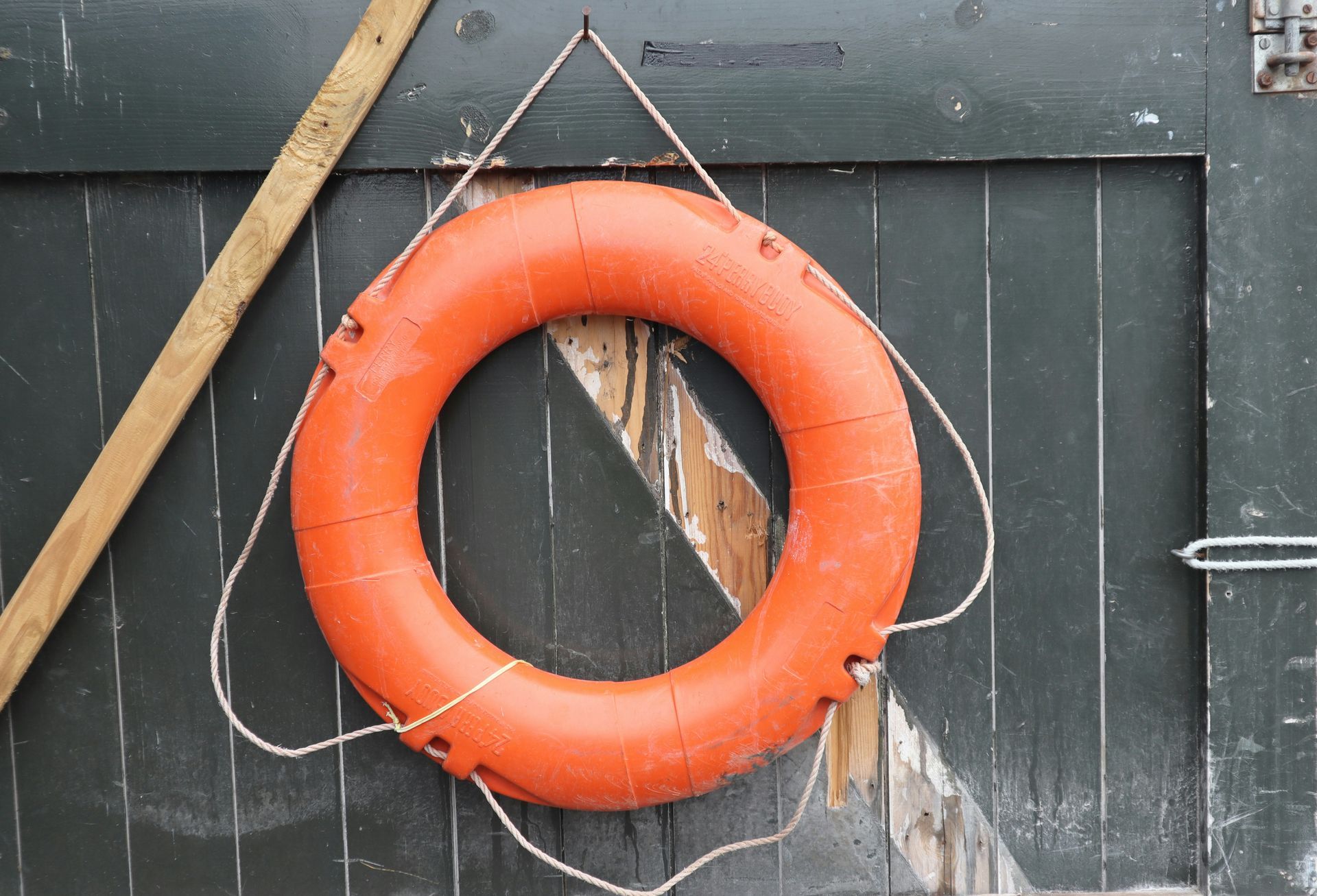 An orange life raft represents the benefits of seeing an out-of-network therapist. 