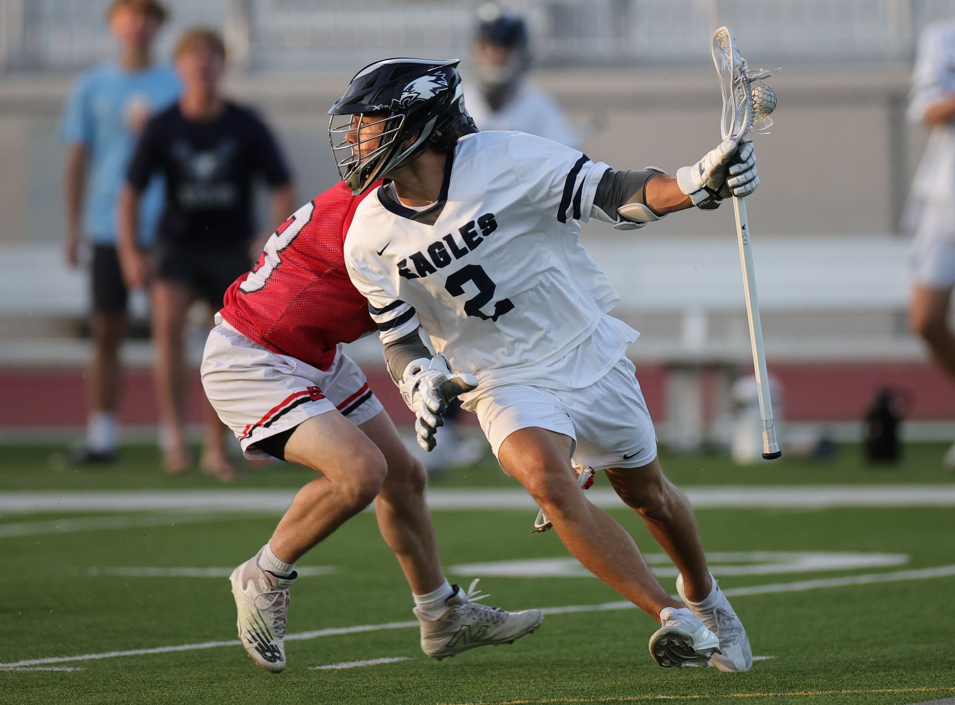 Lacrosse player in white jersey with 