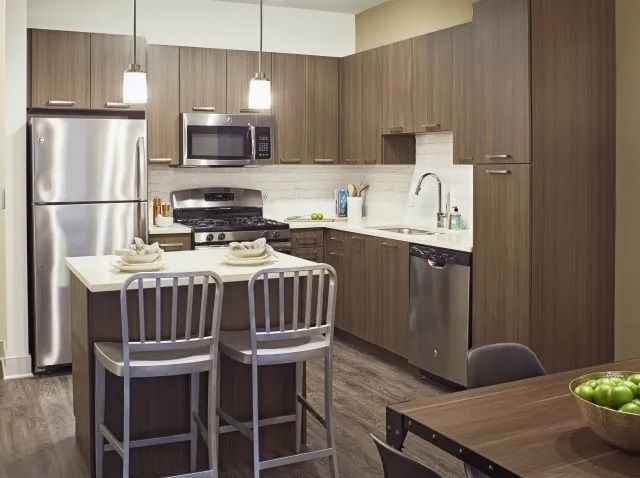 Modern kitchen with island at The Mave in Stoneham, MA. 