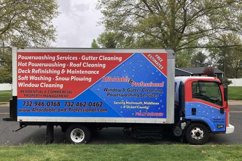 A blue and white truck is parked on the side of the road.